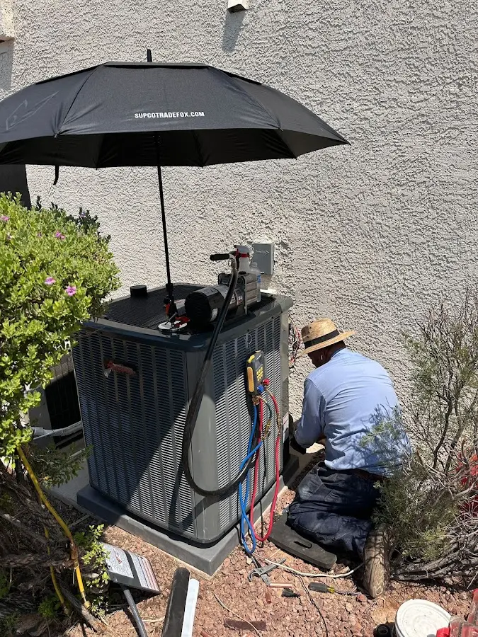 HVAC technician performing outdoor AC maintenance in Lower Southampton
